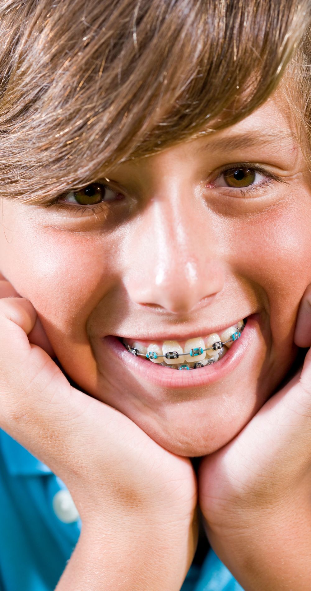 a child smiling with orthodontic braces