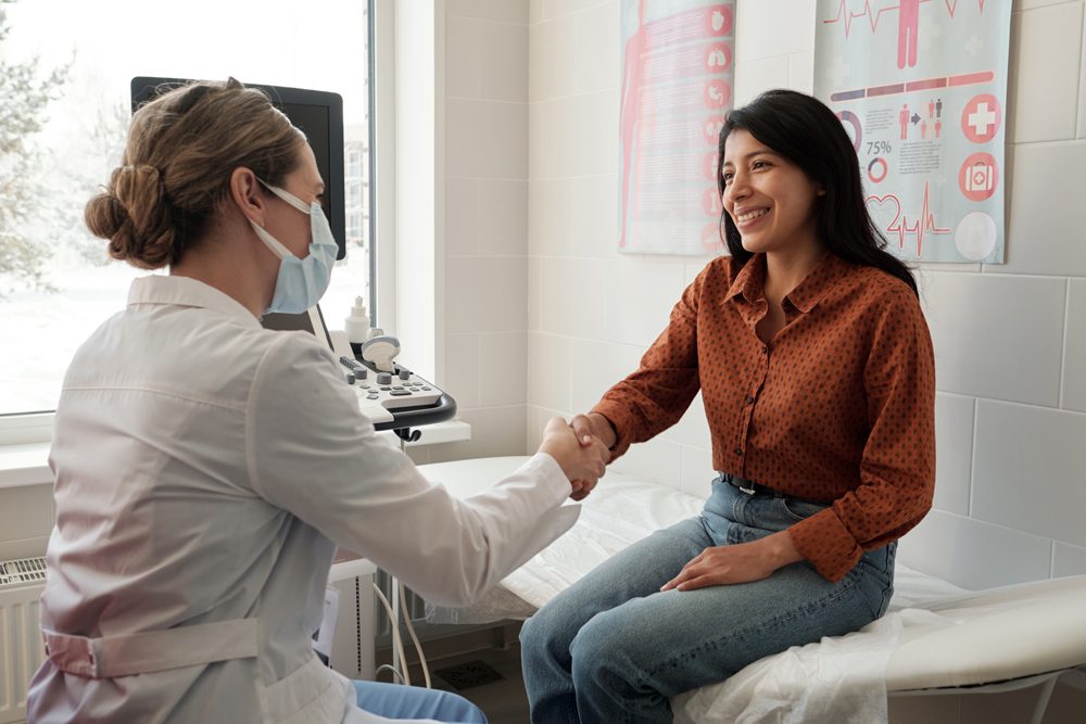 webfemale-clinician-shaking-hand-of-young-happy-hispa-2022-03-09-22-19-58-utc
