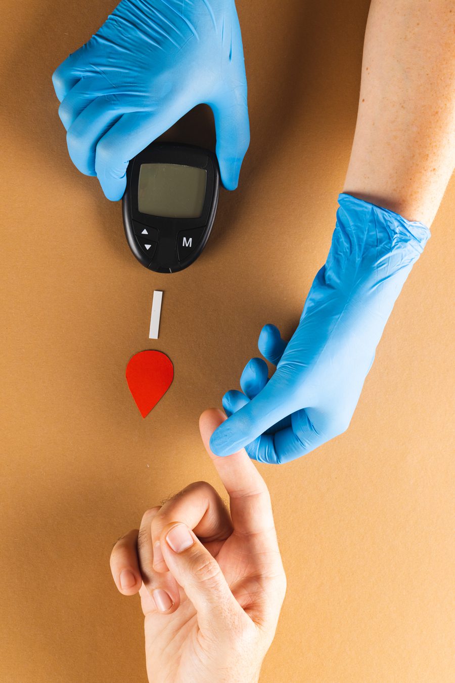 webhands-of-gloved-doctor-with-glucometer-taking-bloo-2023-11-27-05-02-54-utc